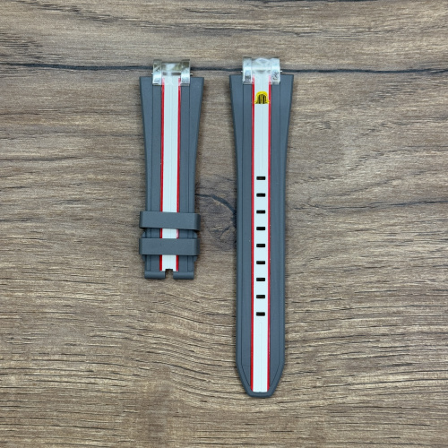 Ремешок для часов Maurice Lacroix из каучука, серый/красный/белый, 24/18 мм Каучуковые ремешки идеально подходят для активного образа жизни. Они легче и теплее металлических браслетов, а ощущаются на руке как вторая кожа. Большое преимущество каучука в том, что он не боится воды. У нас присутствуют только высококачественные материалы и оригинальный товар от производителя